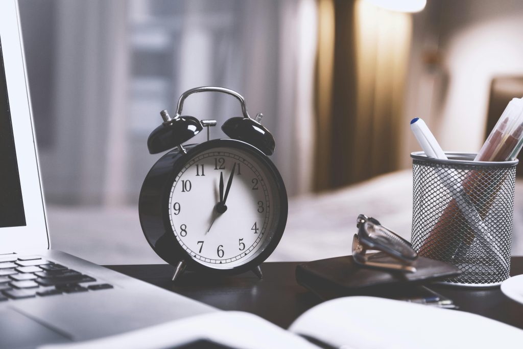 alarm clock on writing desk - find time for writing