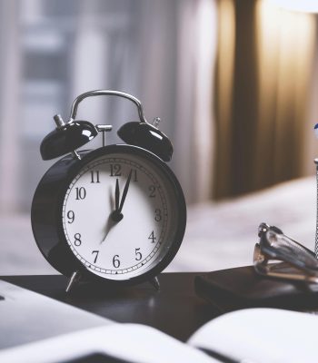 alarm clock on writing desk - find time for writing