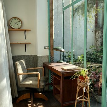 an ideal writing space - a desk next to a sunny window overlooking the garden